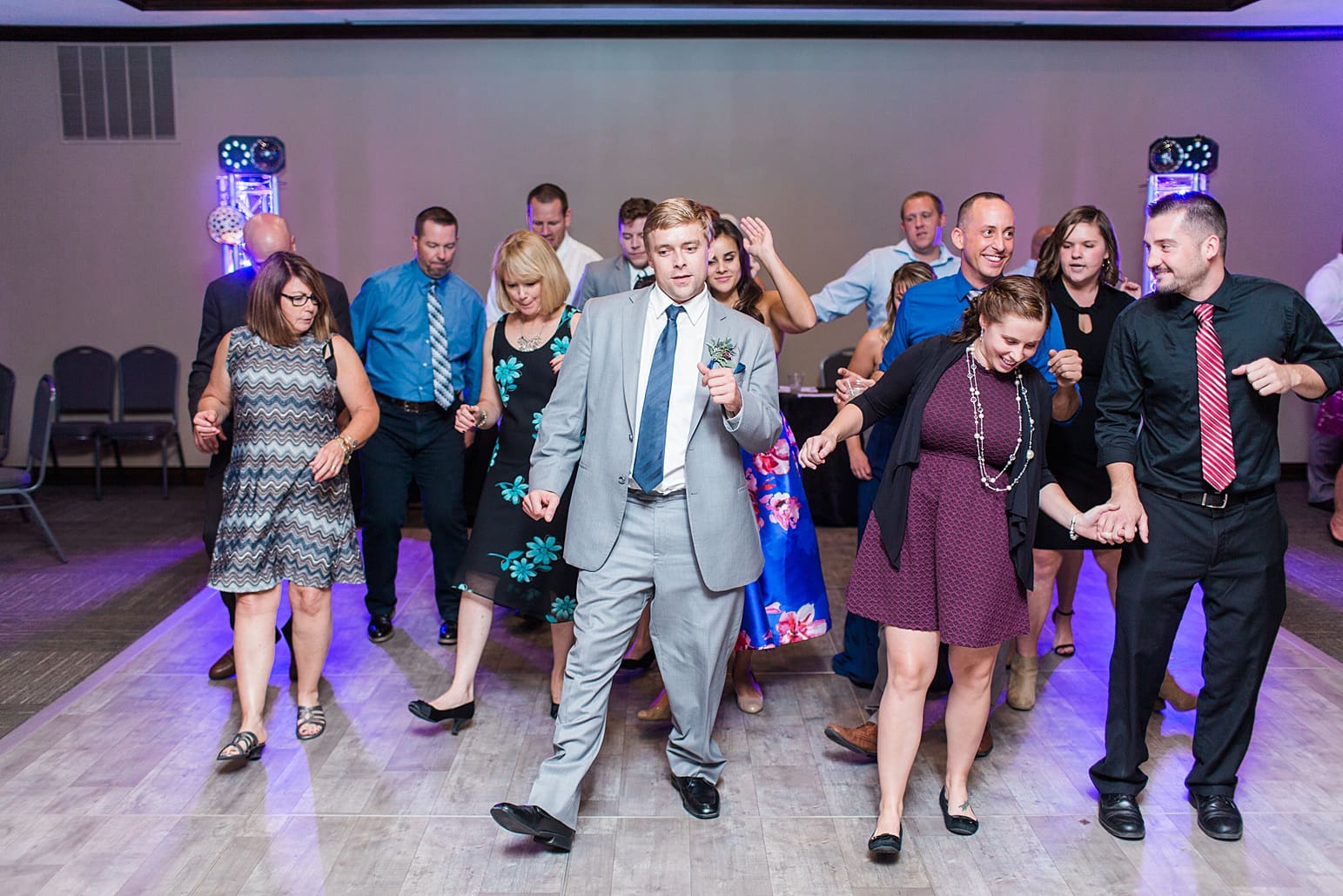 Arielle Peters Photography | Wedding guests dancing on wedding day at Sleepy Owl Restaurant in Syracuse, Indiana.