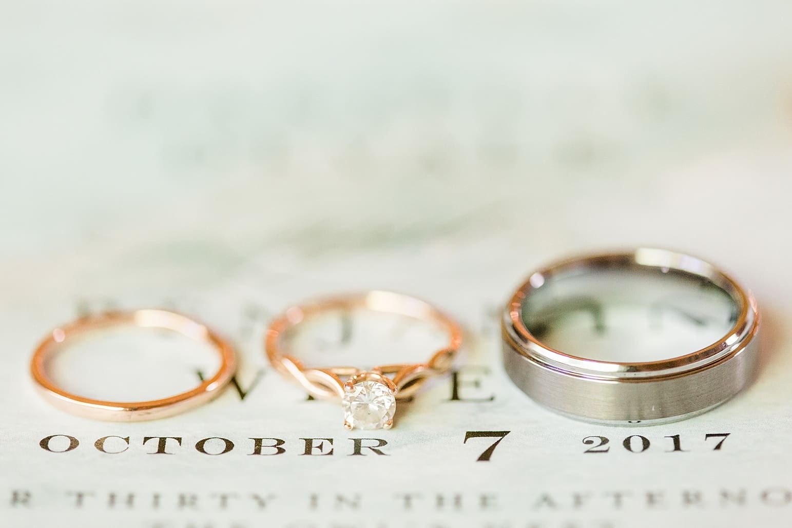 Arielle Peters Photography | Wedding rings on wedding invitation on wedding day in Syracuse, Indiana.