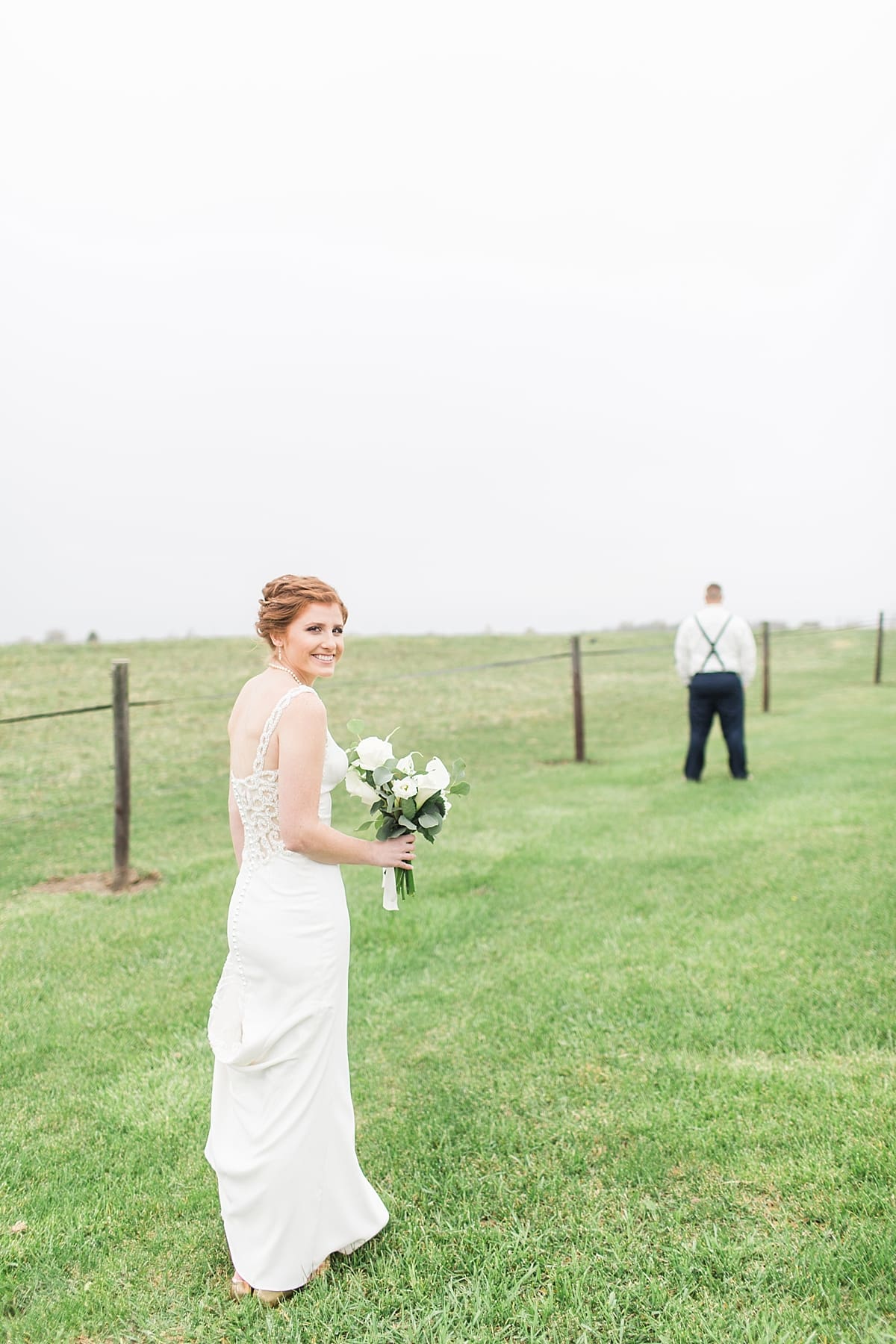 Arielle Peters Photography | Bride and groom having first reveal in open green field on gloomy wedding day in Huntington, Indiana.