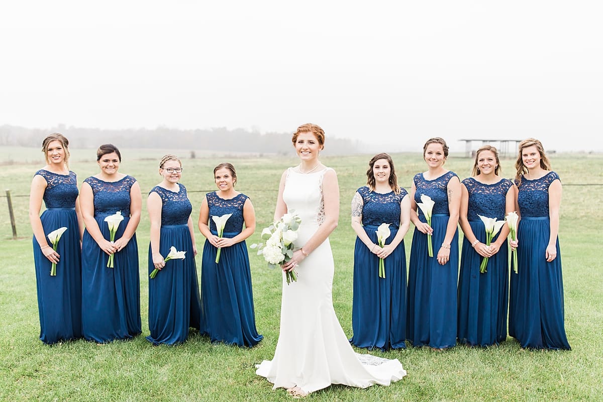 Arielle Peters Photography | Bride and bridesmaids in open green field on gloomy wedding day in Huntington, Indiana.