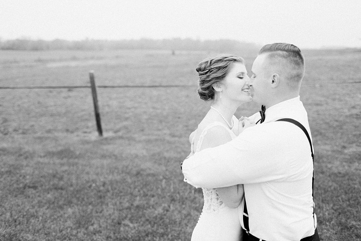 Arielle Peters Photography | Bride and groom almost kissing in open green field on gloomy wedding day in Huntington, Indiana.