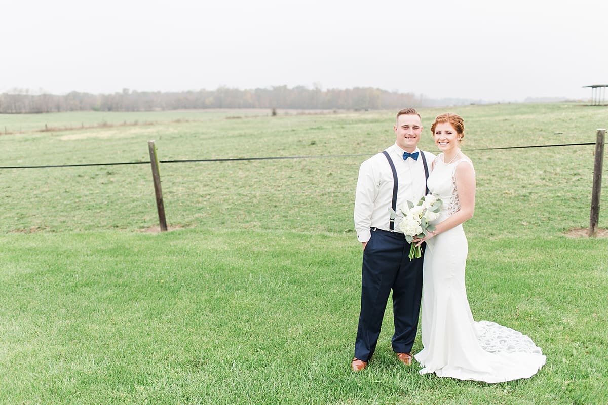 Arielle Peters Photography | Bride and groom in open green field on gloomy wedding day in Huntington, Indiana.