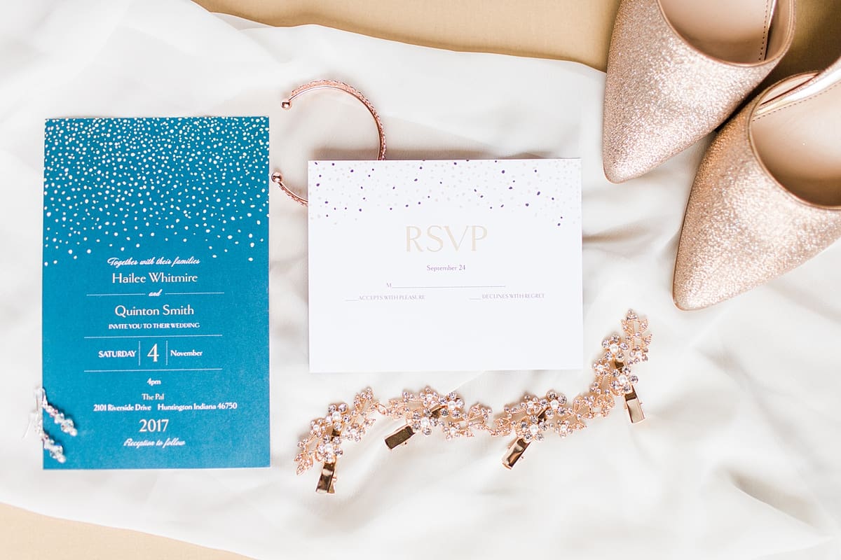 Arielle Peters Photography | Wedding invitations and jewelry on cream background on wedding day in Huntington, Indiana.