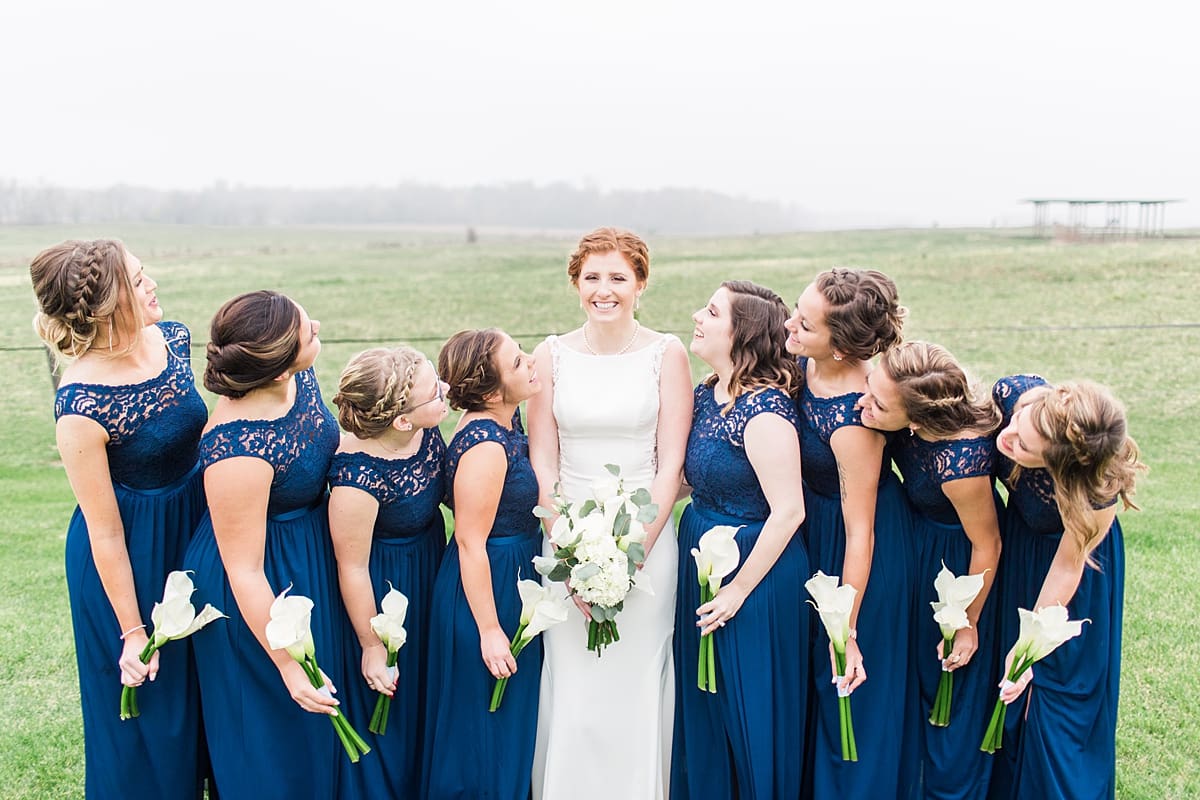 Arielle Peters Photography | Bride and bridesmaids in open green field on gloomy wedding day in Huntington, Indiana.
