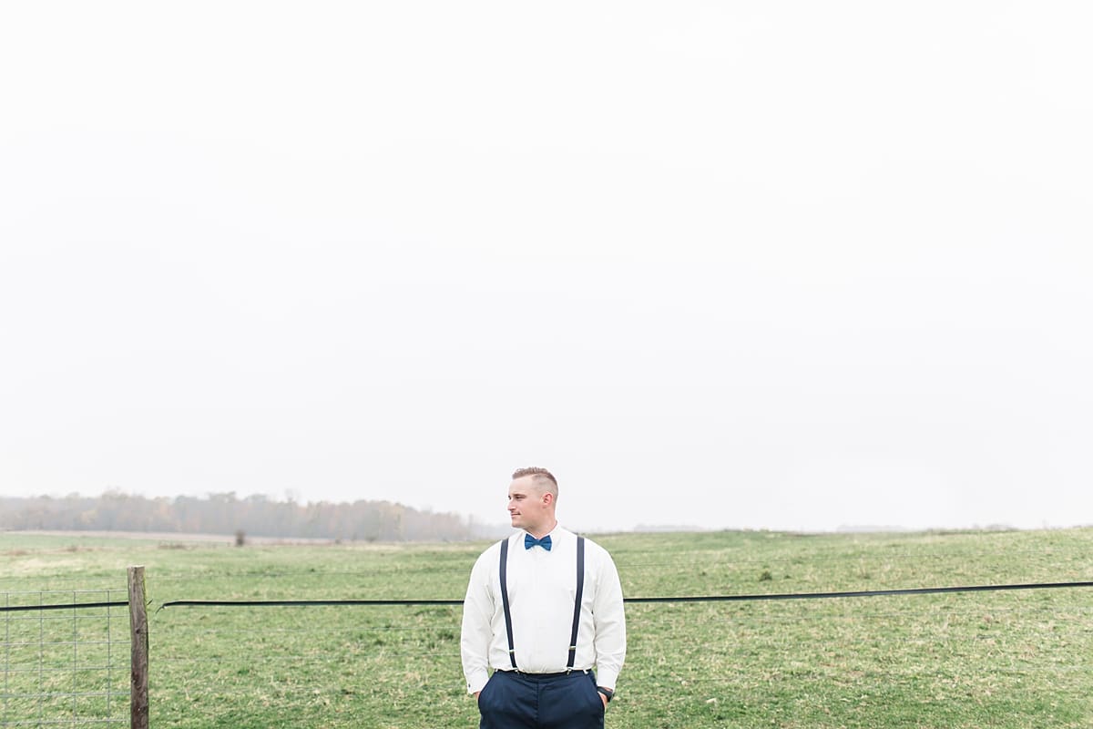 Arielle Peters Photography | Groom with hands in pockets in open green field on gloomy wedding day in Huntington, Indiana.