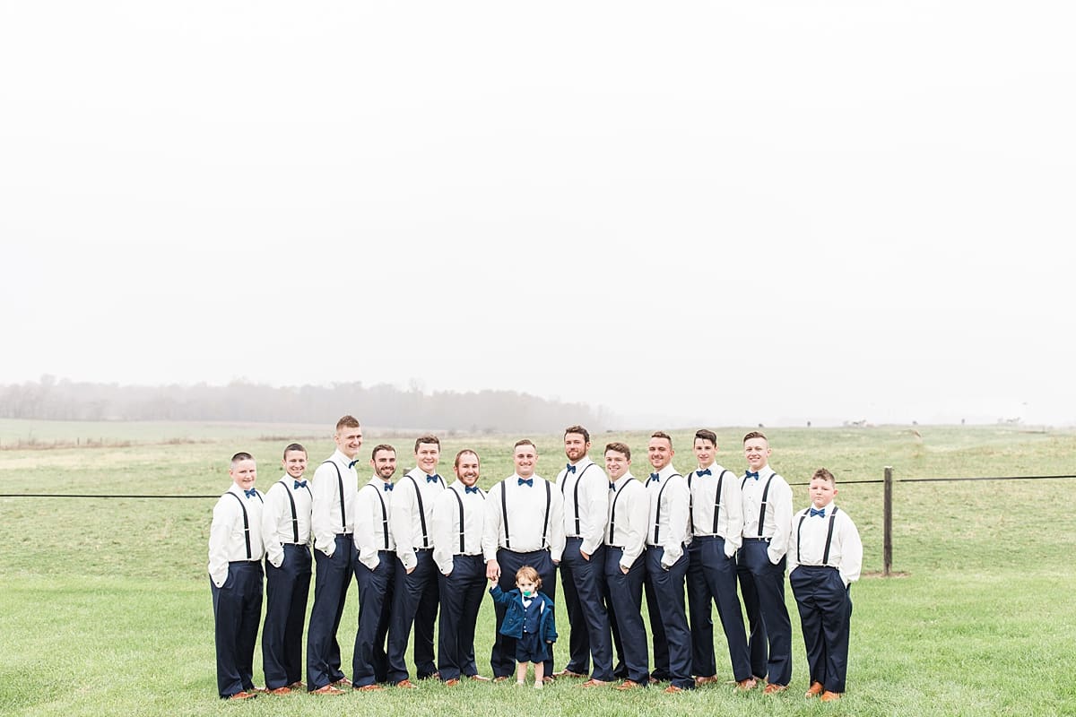 Arielle Peters Photography | Groom and groomsmen in open green field on gloomy wedding day in Huntington, Indiana.