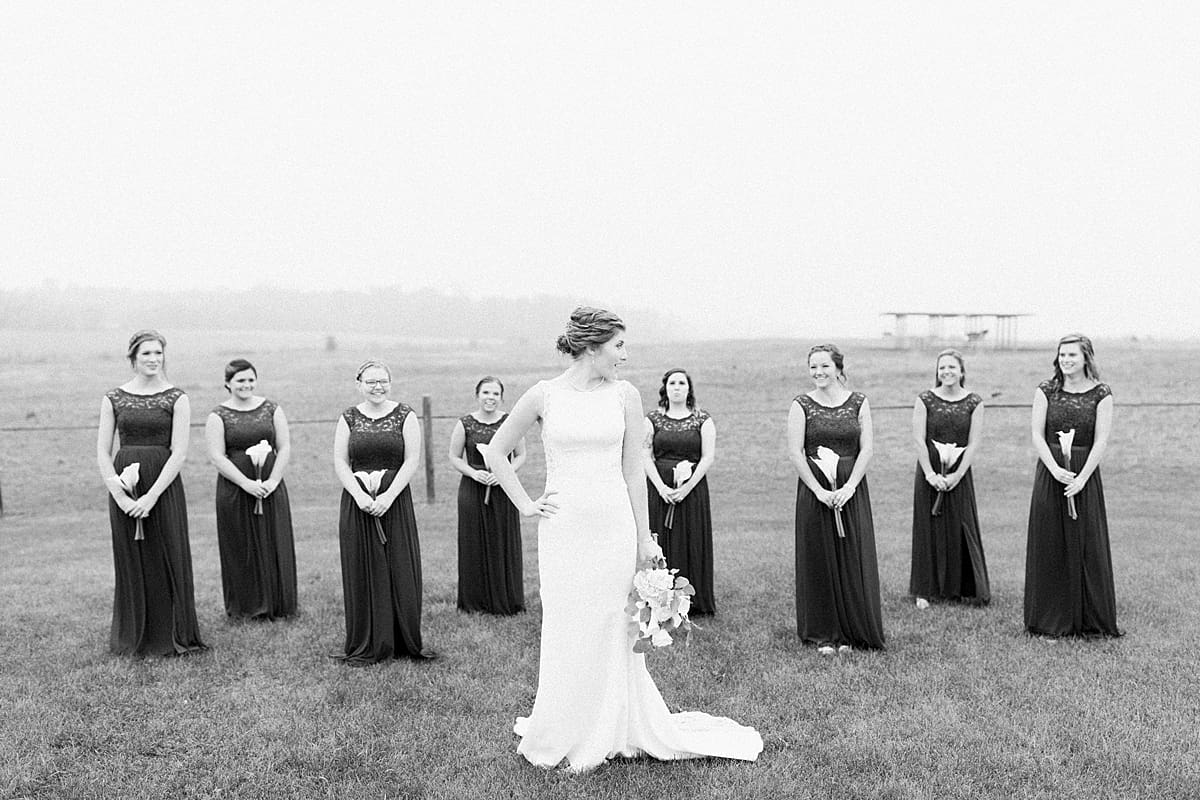 Arielle Peters Photography | Bride and bridesmaids in open green field on gloomy wedding day in Huntington, Indiana.