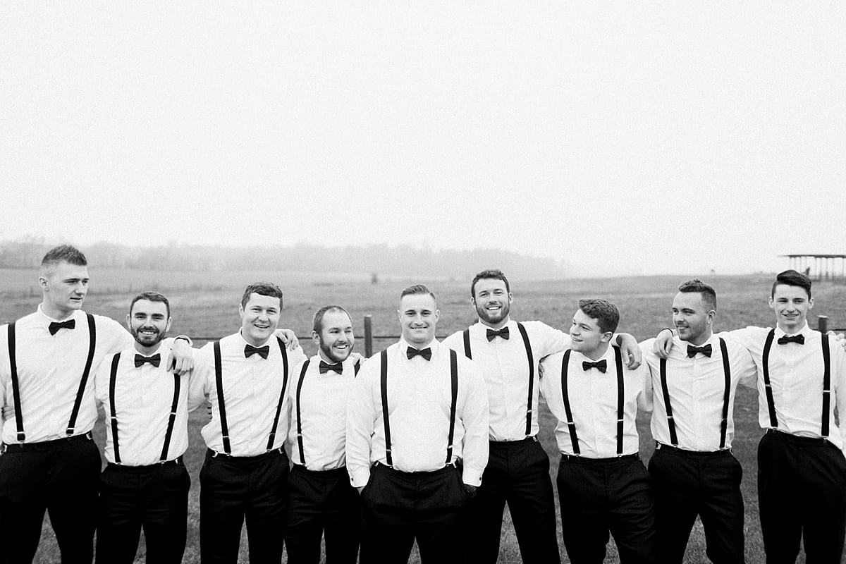 Arielle Peters Photography | Groom and groomsmen in open green field on gloomy wedding day in Huntington, Indiana.