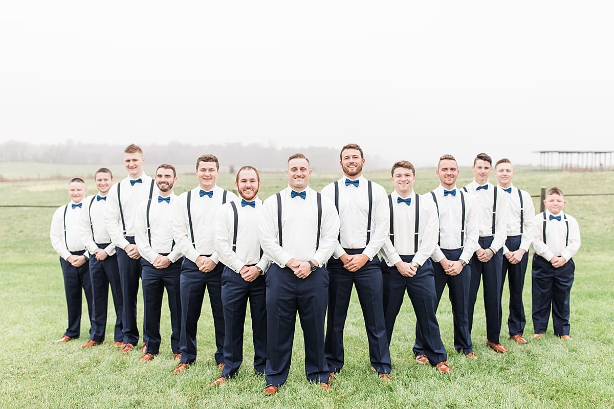 Arielle Peters Photography | Groom and groomsmen in open green field on gloomy wedding day in Huntington, Indiana.