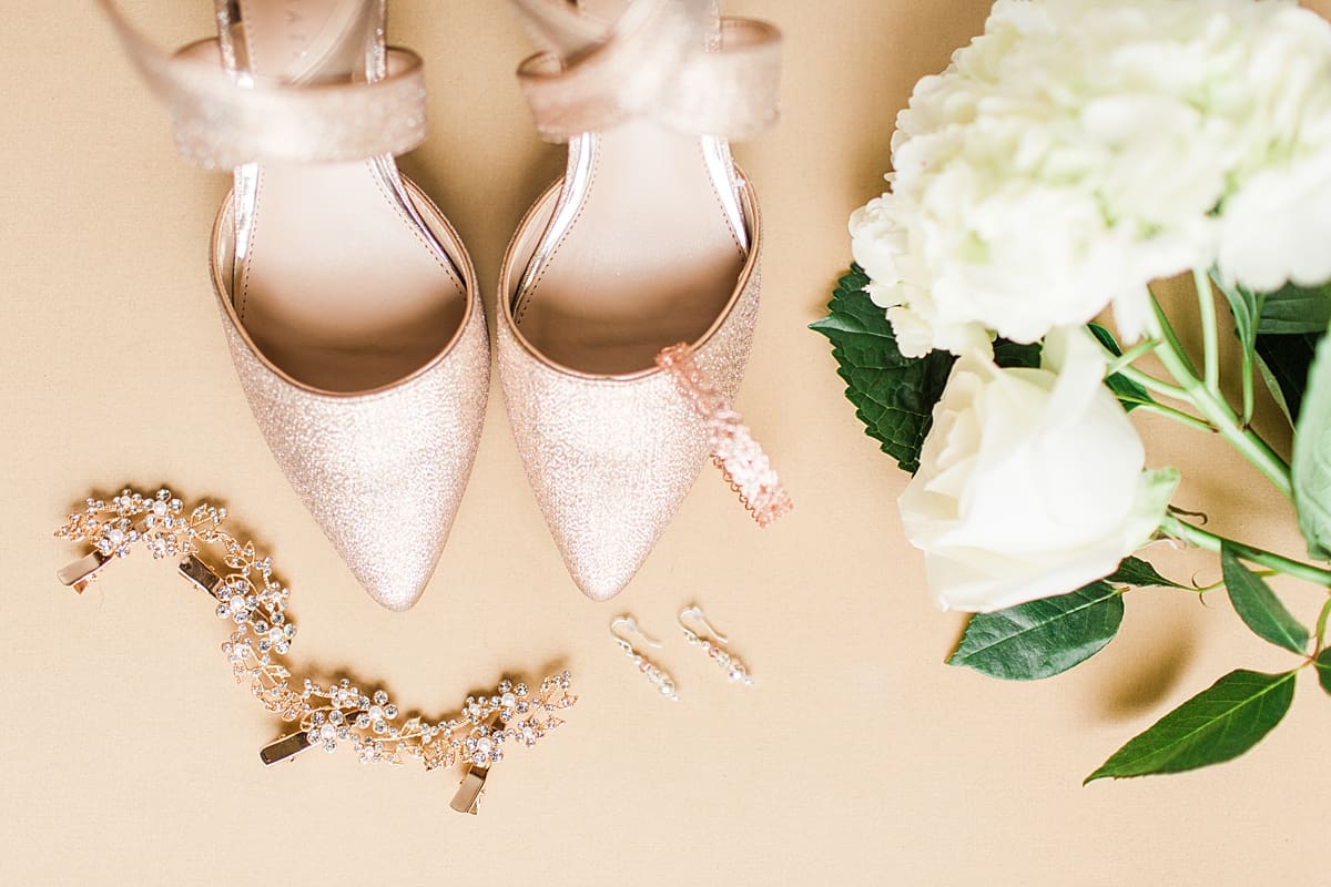 Arielle Peters Photography | Wedding shoes and jewelry on cream background on wedding day in Huntington, Indiana.