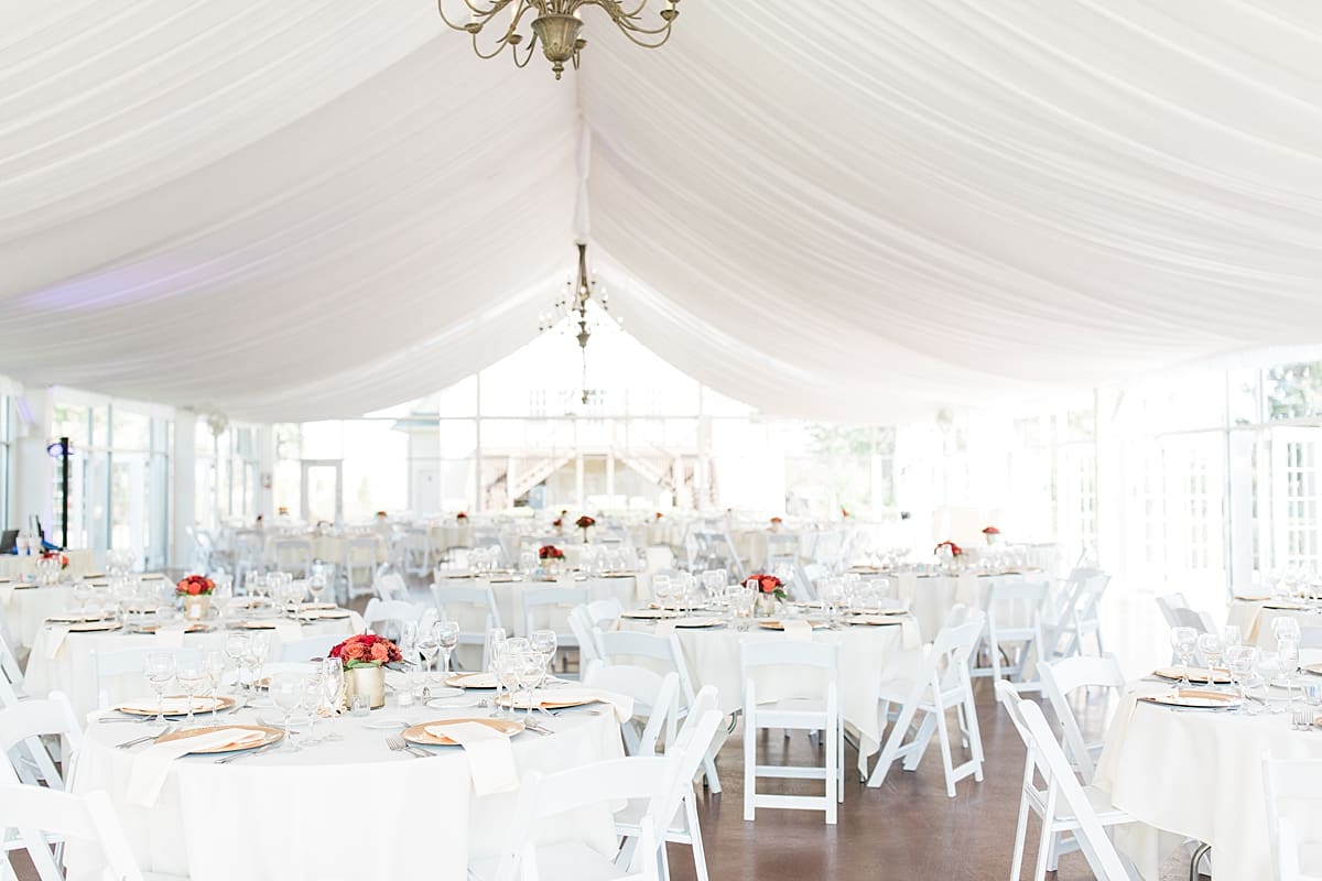 Arielle Peters Photography | All white wedding reception table settings and floral arrangements under tent on wedding day.