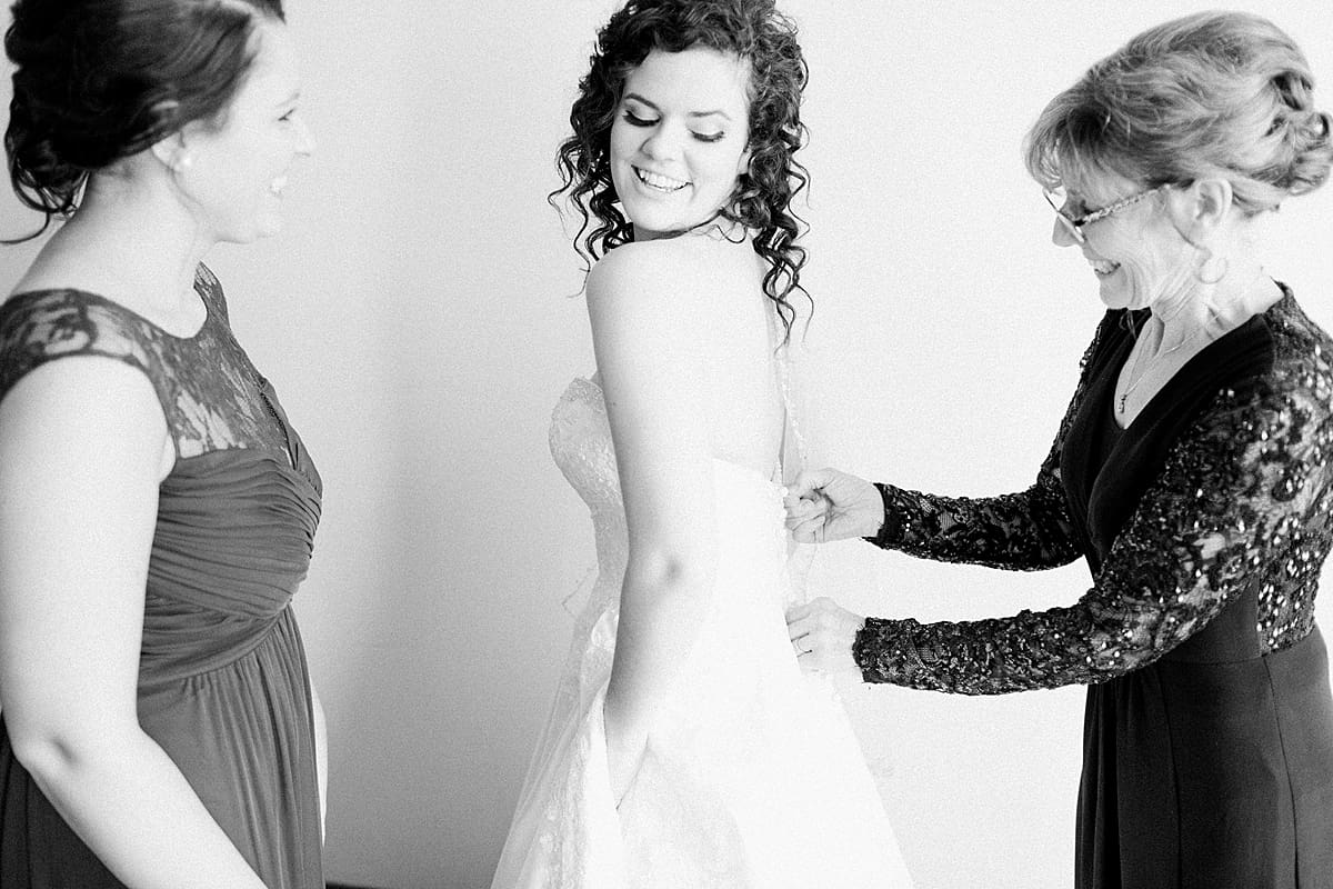 Arielle Peters Photography | Mother of bride helping bride get ready on wedding day.