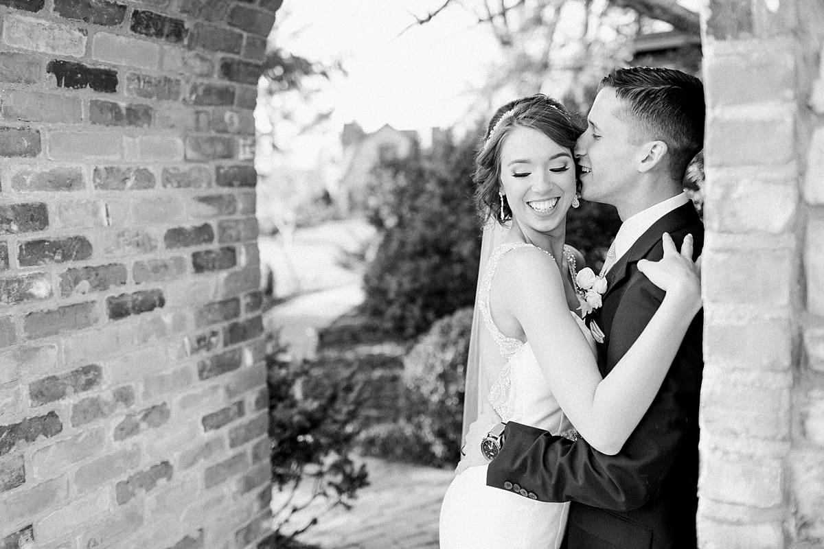 Arielle Peters Photography | Bride and groom almost kissing under a brick archway on wedding day.