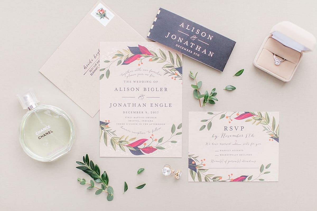 Arielle Peters Photography | Wedding invitation and bridal perfume on cream background on wedding day.