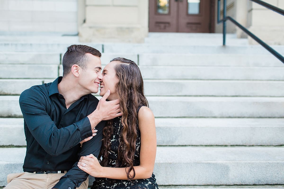 Arielle Peters Photography | Young couple almost kissing sitting on stone steps taking summer engagement photos. 