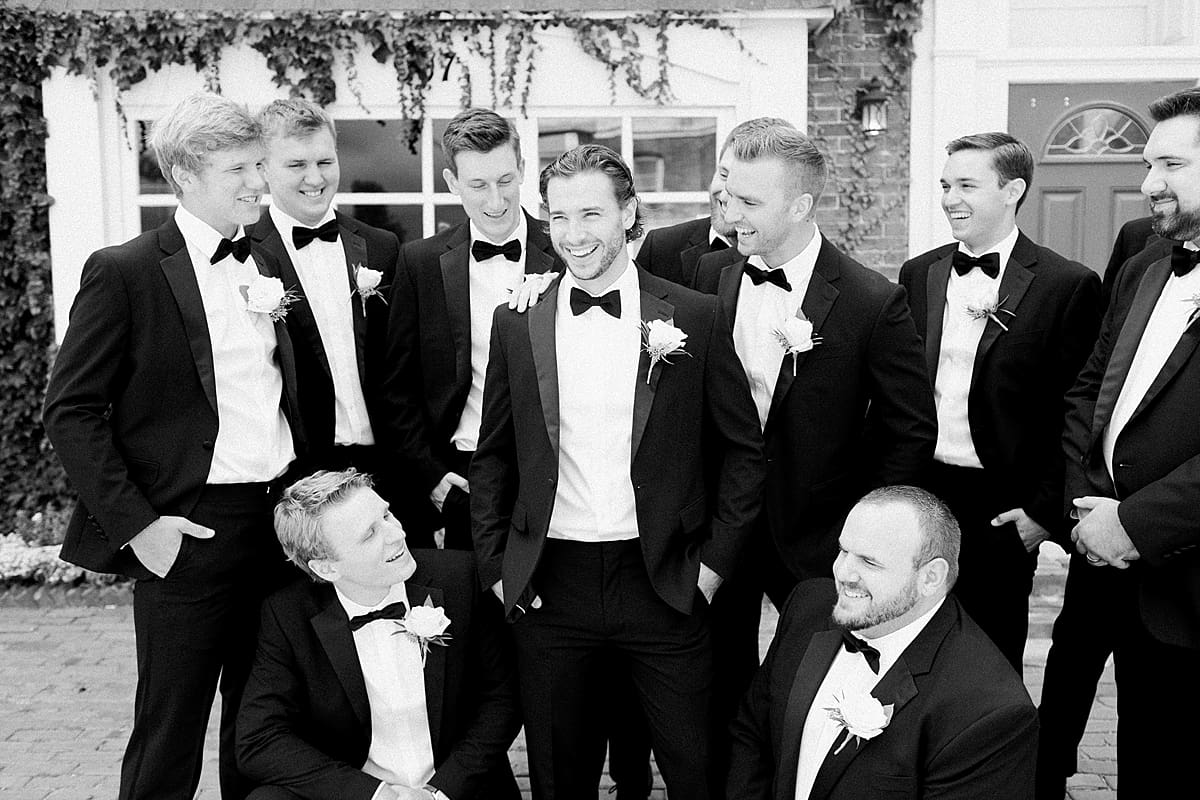 Arielle Peters Photography | Groom and groomsmen laughing in their tuxes on wedding day.