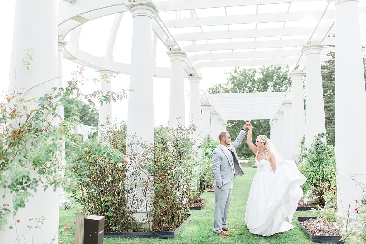 Arielle Peters Photography | Bride and bridesmaids dancing in overgrown rose garden on wedding day.