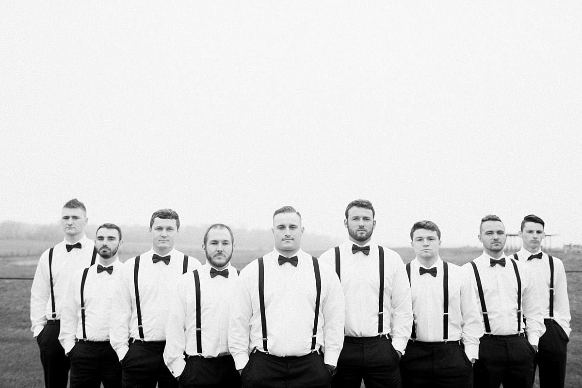 Arielle Peters Photography | Groom and groomsmen standing with hands in pockets on gloomy wedding day.