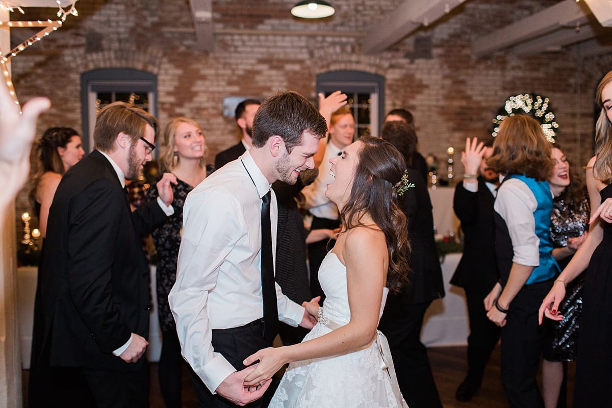 Arielle Peters Photography | Bride and groom laughing and dancing at wedding reception on winter wedding day in Goshen, Indiana.