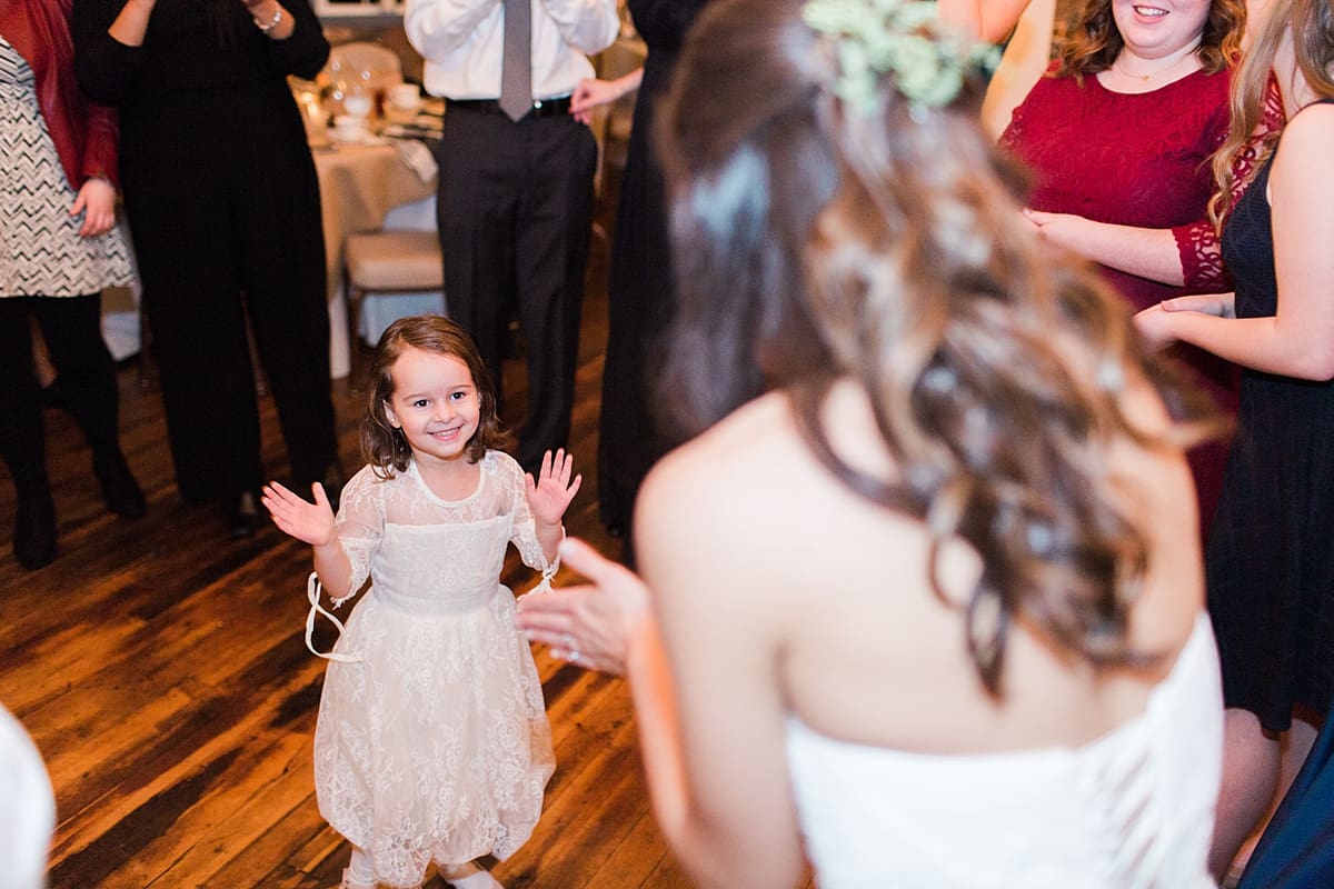 Arielle Peters Photography | Bride dancing with little girl at wedding reception on winter wedding day in Goshen, Indiana.