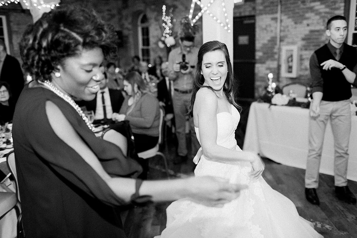 Arielle Peters Photography | Bride dancing with friends at wedding reception on winter wedding day in Goshen, Indiana.