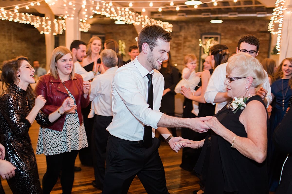 Arielle Peters Photography | Groom dancing with friends at wedding reception on winter wedding day in Goshen, Indiana.