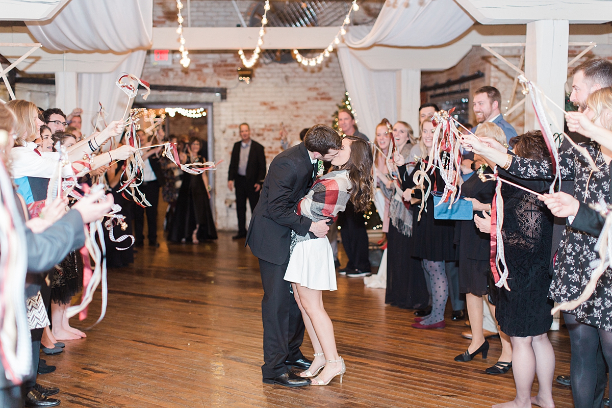 Arielle Peters Photography | Bride and groom kissing during send off at wedding reception on winter wedding day in Goshen, Indiana.