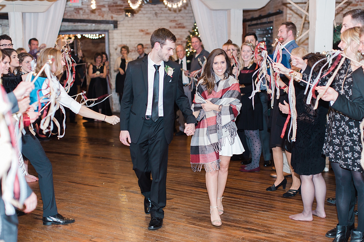 Arielle Peters Photography | Bride and groom walking out to send off at wedding reception on winter wedding day in Goshen, Indiana.