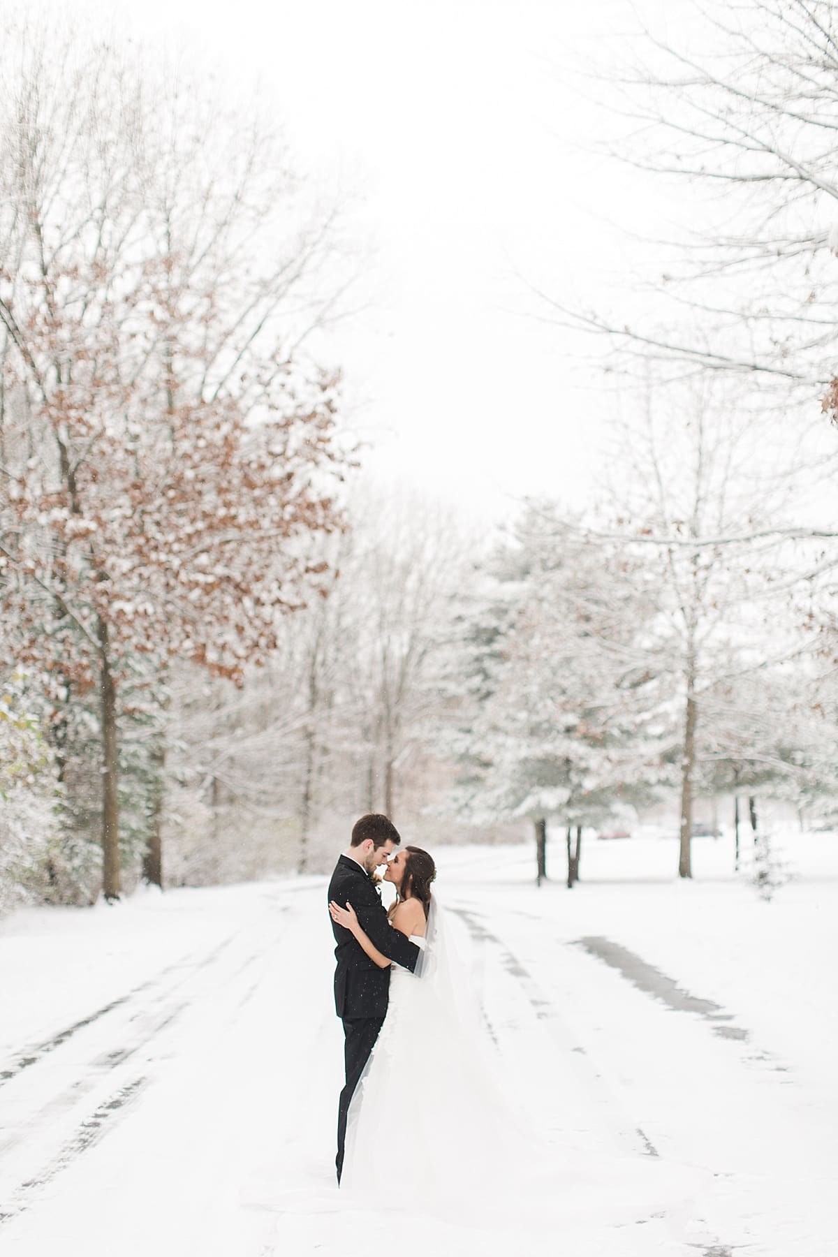 Arielle Peters Photography | Bride and groom on snowy street on winter wedding day in Goshen, Indiana.