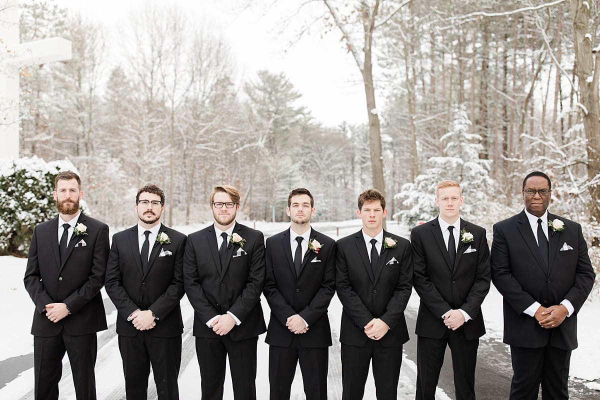 Arielle Peters Photography | Groom and groomsmen on snowy streets on winter wedding day in Goshen, Indiana.