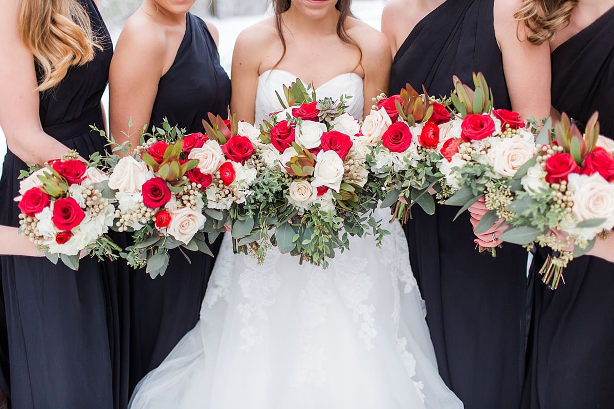 Arielle Peters Photography | Bride and bridesmaids bouquets in the snow on winter wedding day in Goshen, Indiana.