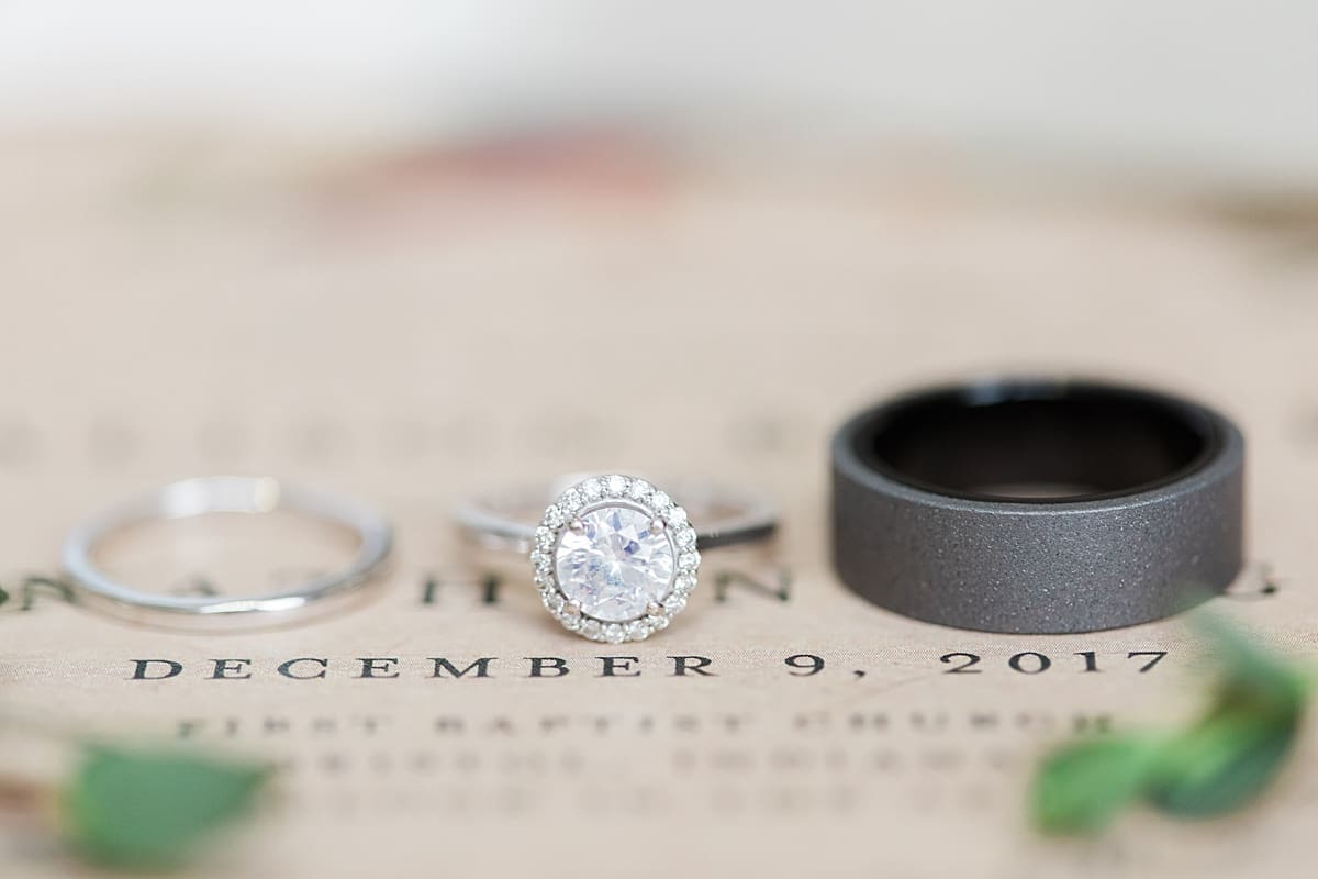 Arielle Peters Photography | Wedding rings on wedding invitation on winter wedding day in Goshen, Indiana.