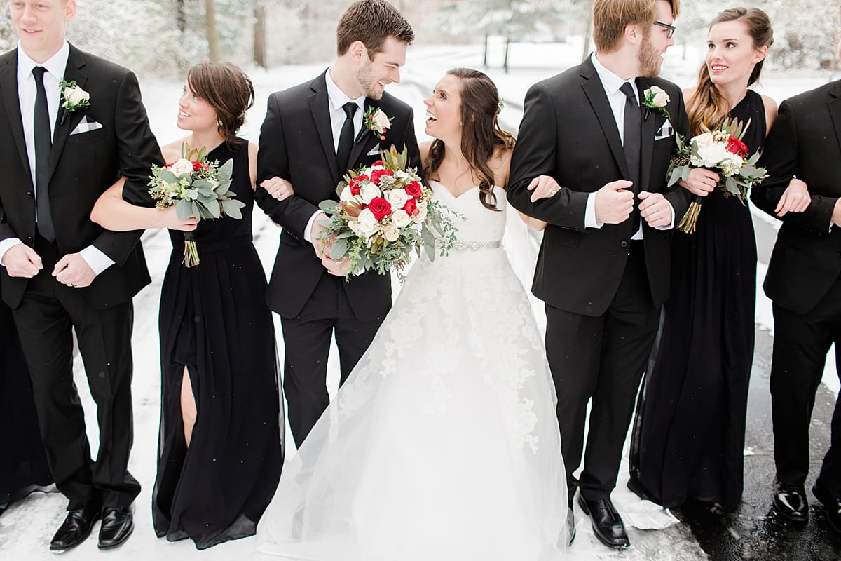 Arielle Peters Photography | Wedding party walking on snowy street on winter wedding day in Goshen, Indiana.
