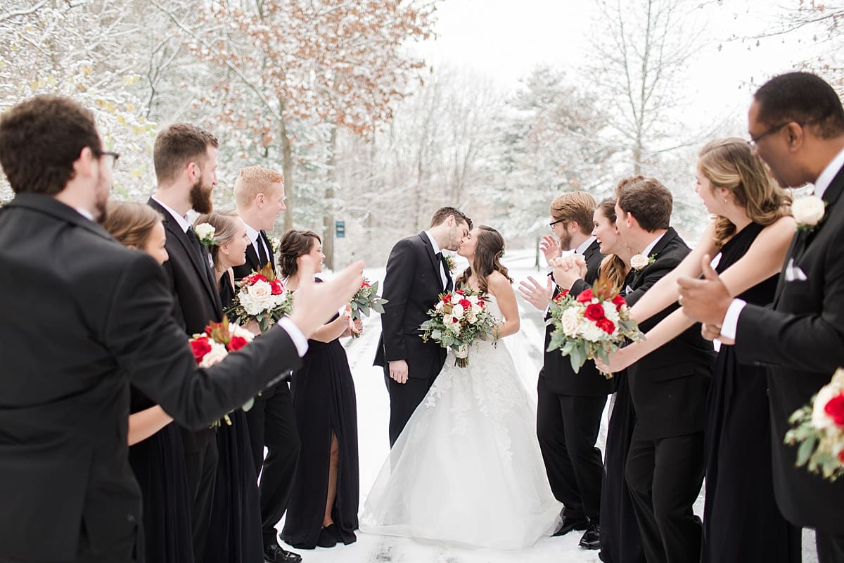 Arielle Peters Photography | Bride and groom kissing in the snow on snowy streets on winter wedding day in Goshen, Indiana.