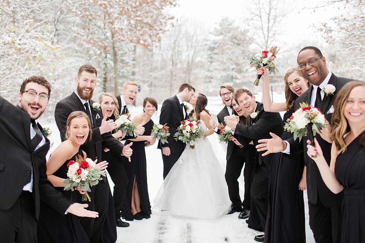 Arielle Peters Photography | Bride and groom kissing in the snow on snowy streets on winter wedding day in Goshen, Indiana.