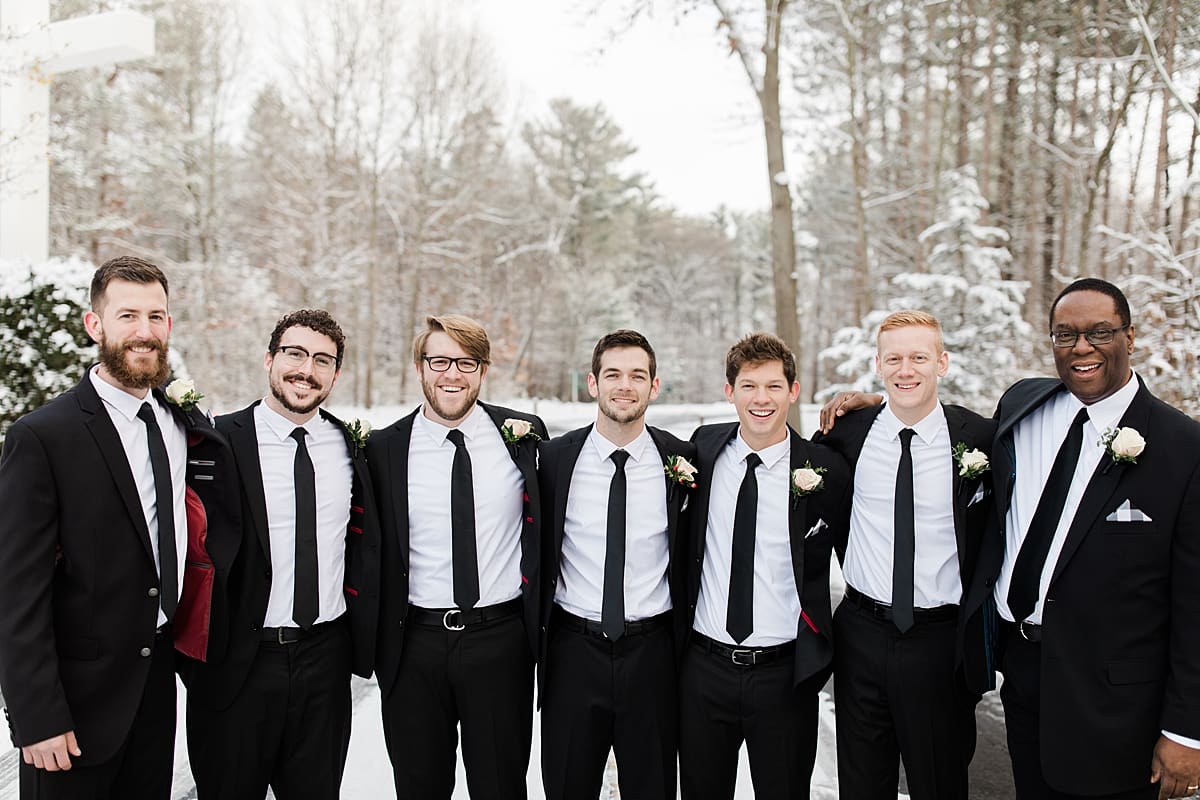 Arielle Peters Photography | Groom and groomsmen on snowy streets on winter wedding day in Goshen, Indiana.
