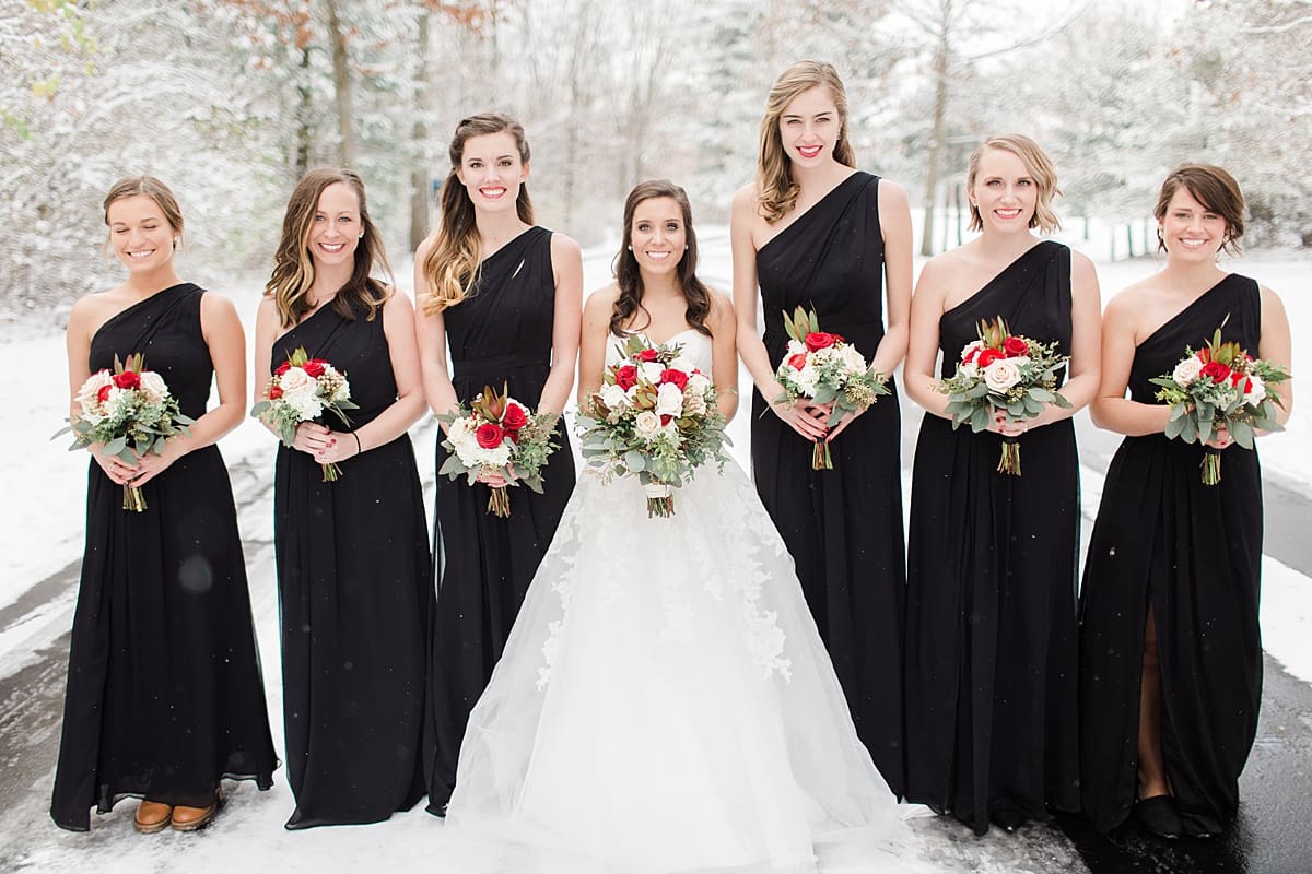 Arielle Peters Photography | Bride and bridesmaids on snowy streets on winter wedding day in Goshen, Indiana.