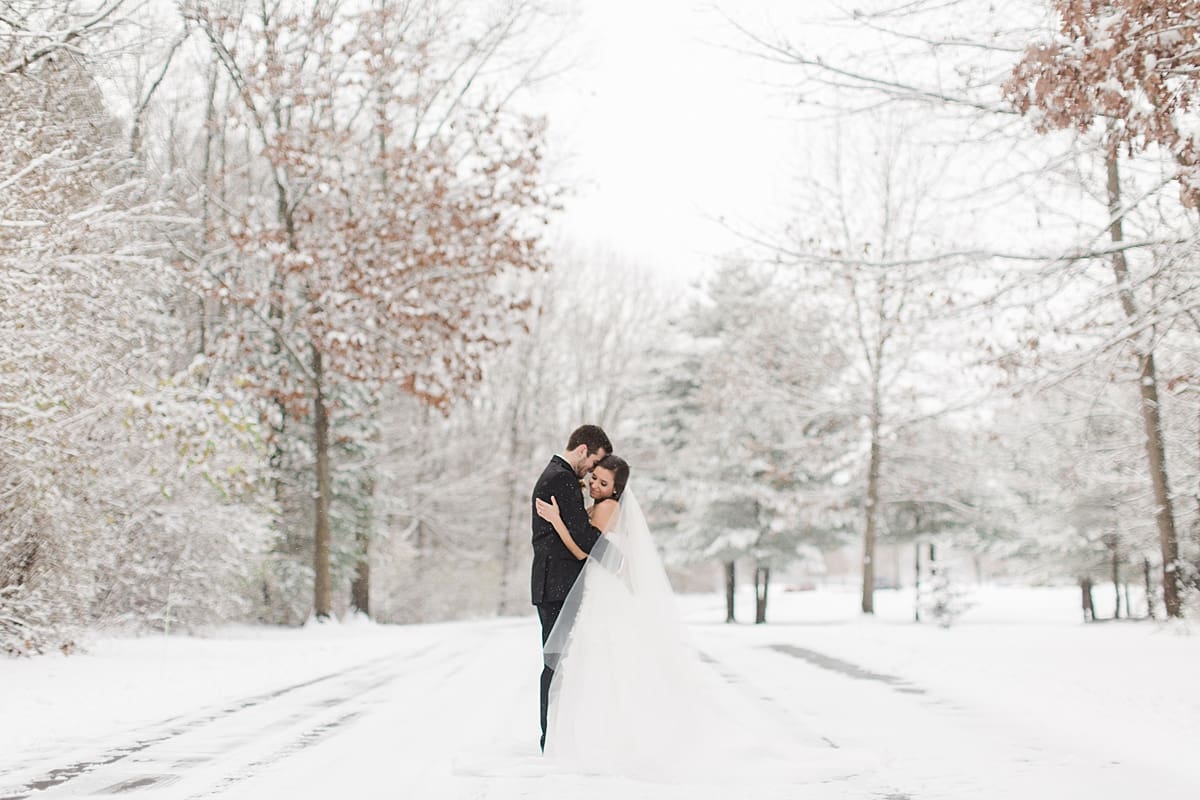 Arielle Peters Photography | Bride and groom dancing on snowy streets on winter wedding day in Goshen, Indiana.