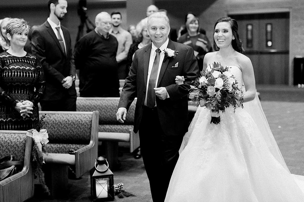 Arielle Peters Photography | Father of bride walking bride down the aisle on winter wedding day in Goshen, Indiana.