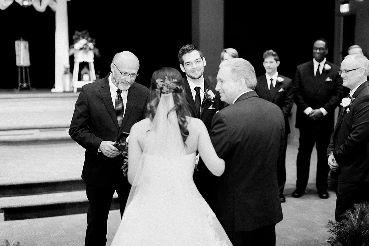 Arielle Peters Photography | Father of bride walking bride down the aisle on winter wedding day in Goshen, Indiana.