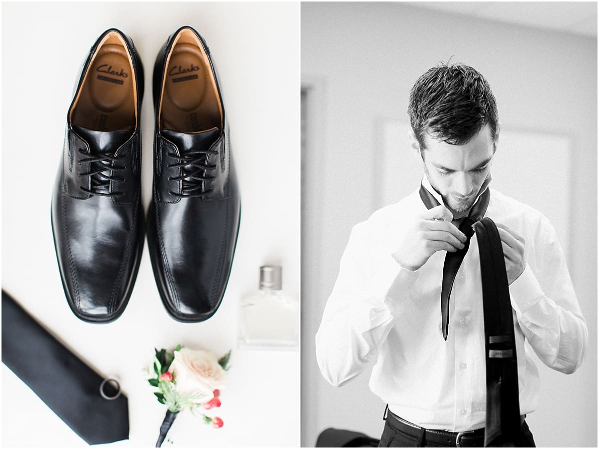 Arielle Peters Photography | Groom putting on his tie getting ready on winter wedding day in Goshen, Indiana.