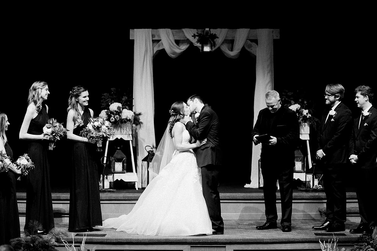 Arielle Peters Photography | Bride and groom kissing at the alter on winter wedding day in Goshen, Indiana.