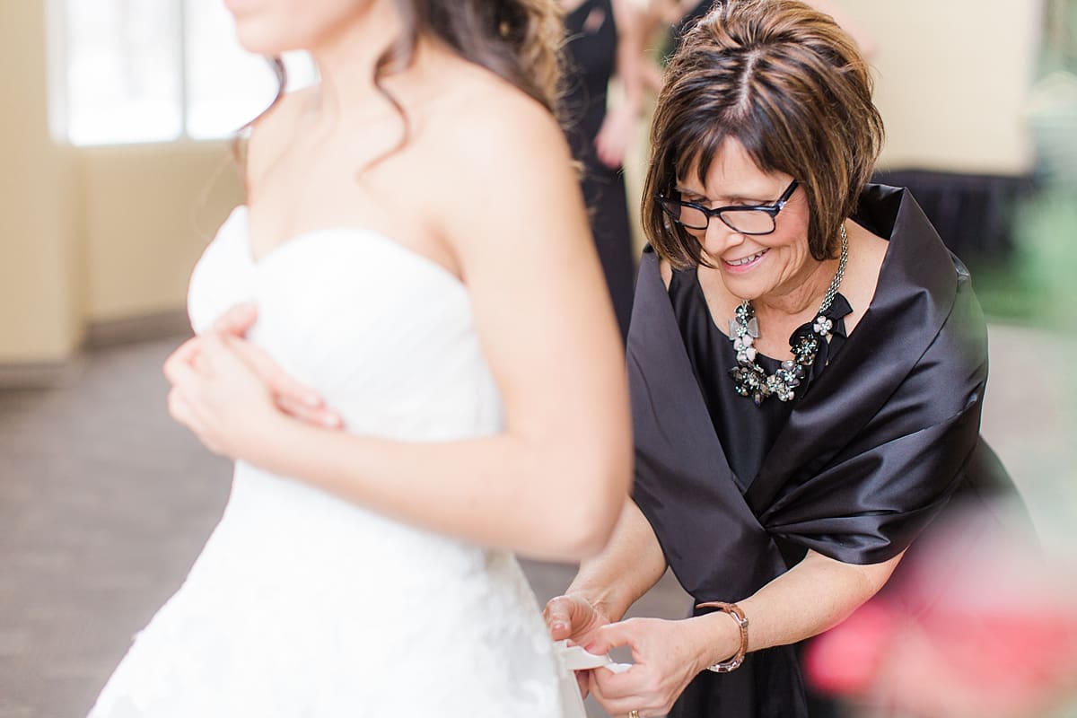 Arielle Peters Photography | Mother of bride helping bride get ready on winter wedding day in Goshen, Indiana.