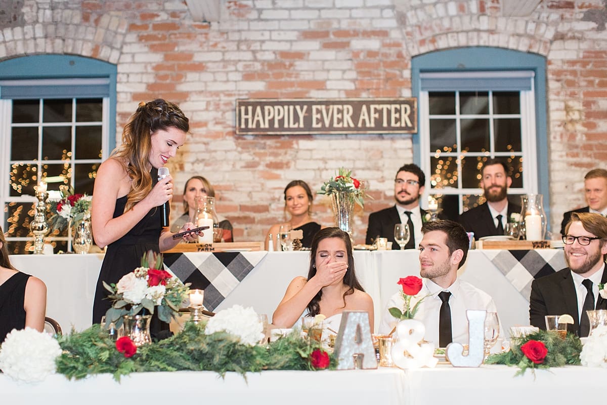 Arielle Peters Photography | Bride and groom laughing during speeches at wedding reception on winter wedding day in Goshen, Indiana.