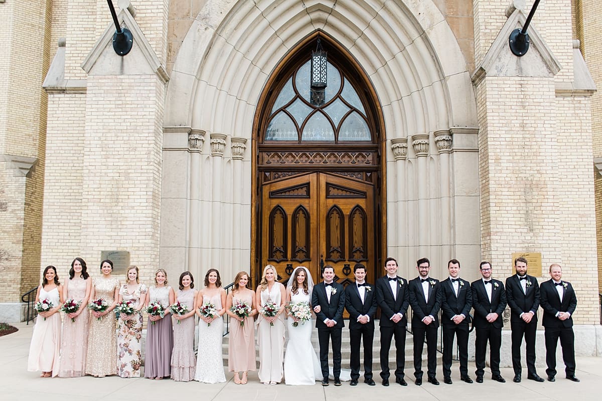 Arielle Peters Photography | Wedding party in front of cathedral doors on wedding day at the Basilica of the Sacred Heart in Notre Dame, Indiana.