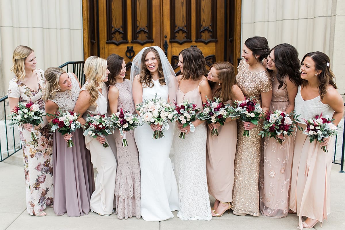 Arielle Peters Photography | Bride and bridesmaids in front of cathedral doors on wedding day at the Basilica of the Sacred Heart in Notre Dame, Indiana.