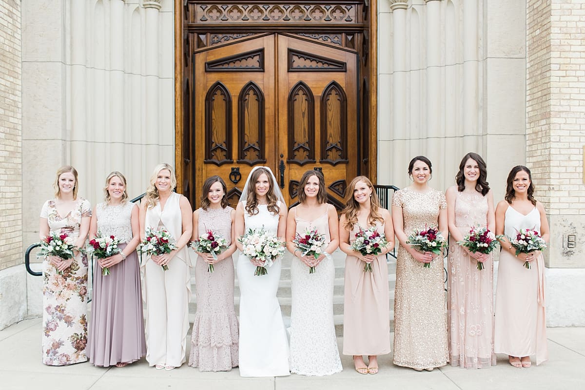 Arielle Peters Photography | Bride and bridesmaids in front of cathedral doors on wedding day at the Basilica of the Sacred Heart in Notre Dame, Indiana.