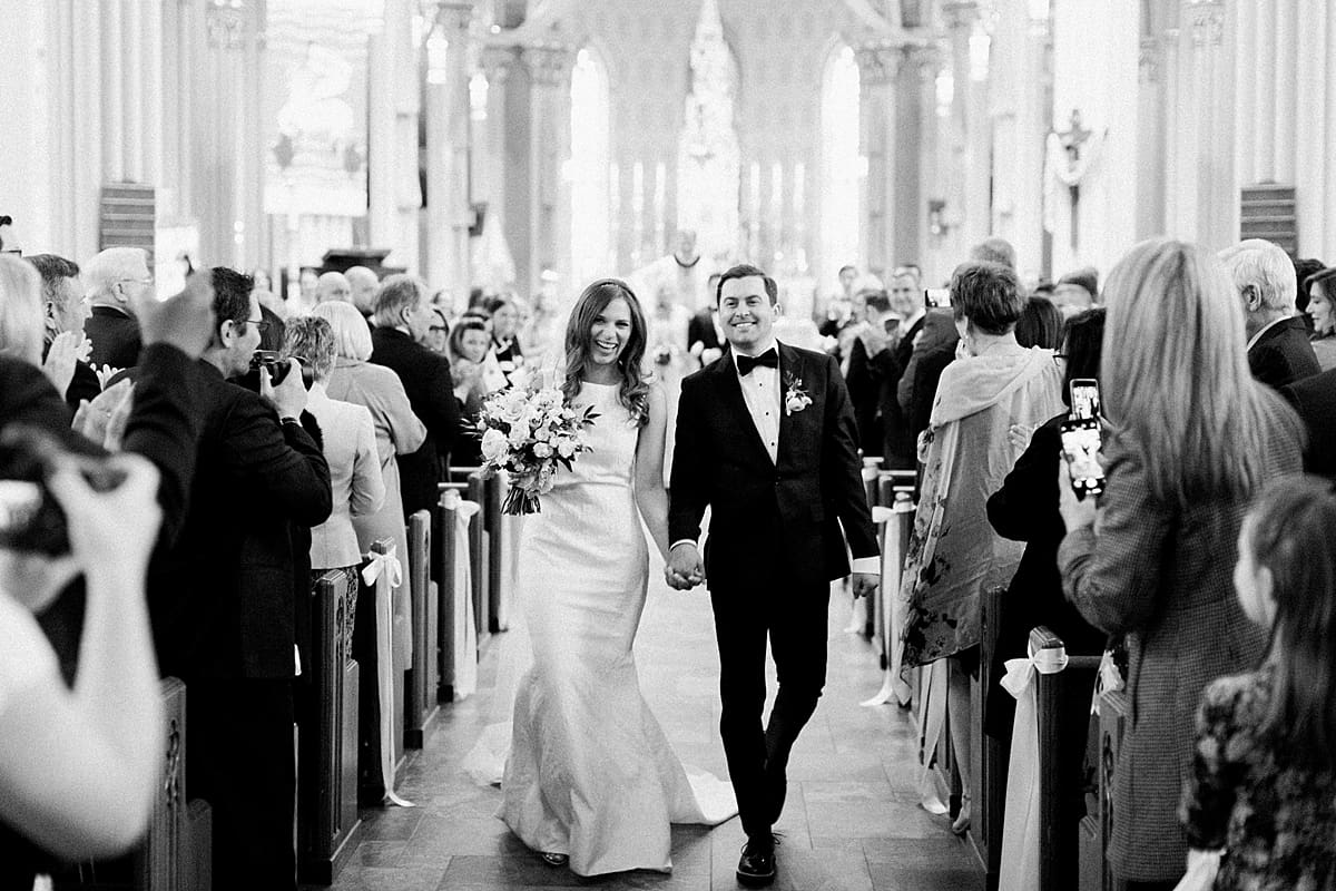 Arielle Peters Photography | Bride and groom walking down the aisle inside cathedral on wedding day at the Basilica of the Sacred Heart in Notre Dame, Indiana.
