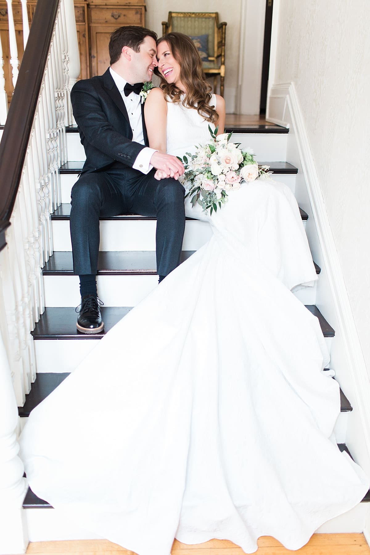Arielle Peters Photography | Bride and groom sitting inside on stairs on wedding day at the Basilica of the Sacred Heart in Notre Dame, Indiana.