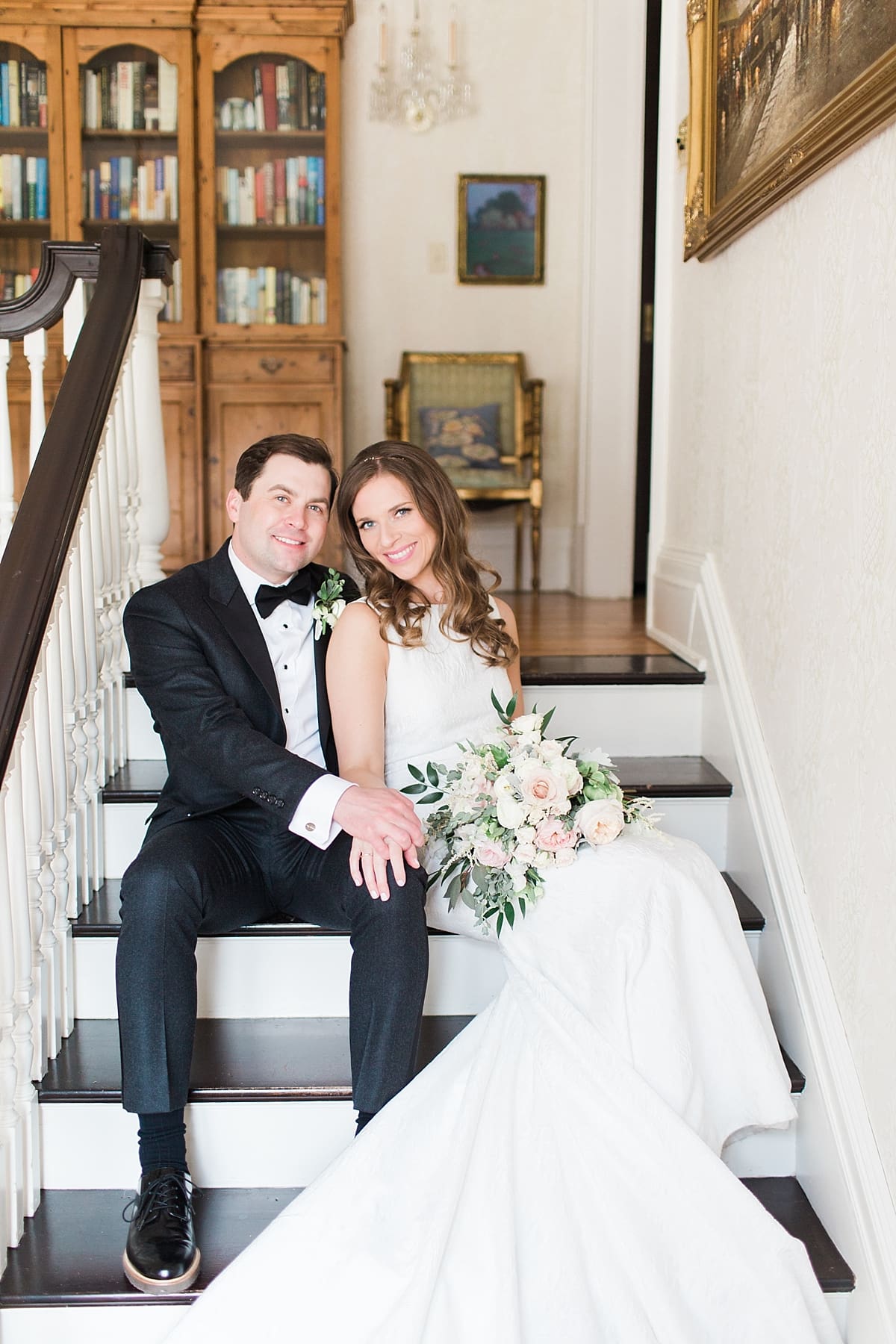 Arielle Peters Photography | Bride and groom sitting on stairwell inside cathedral on wedding day at the Basilica of the Sacred Heart in Notre Dame, Indiana.